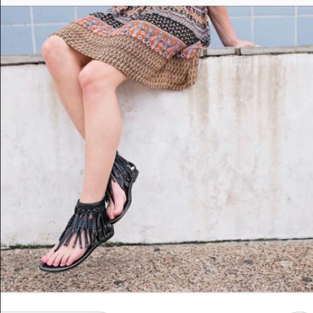 Black fringe sandals by Sam Edelman